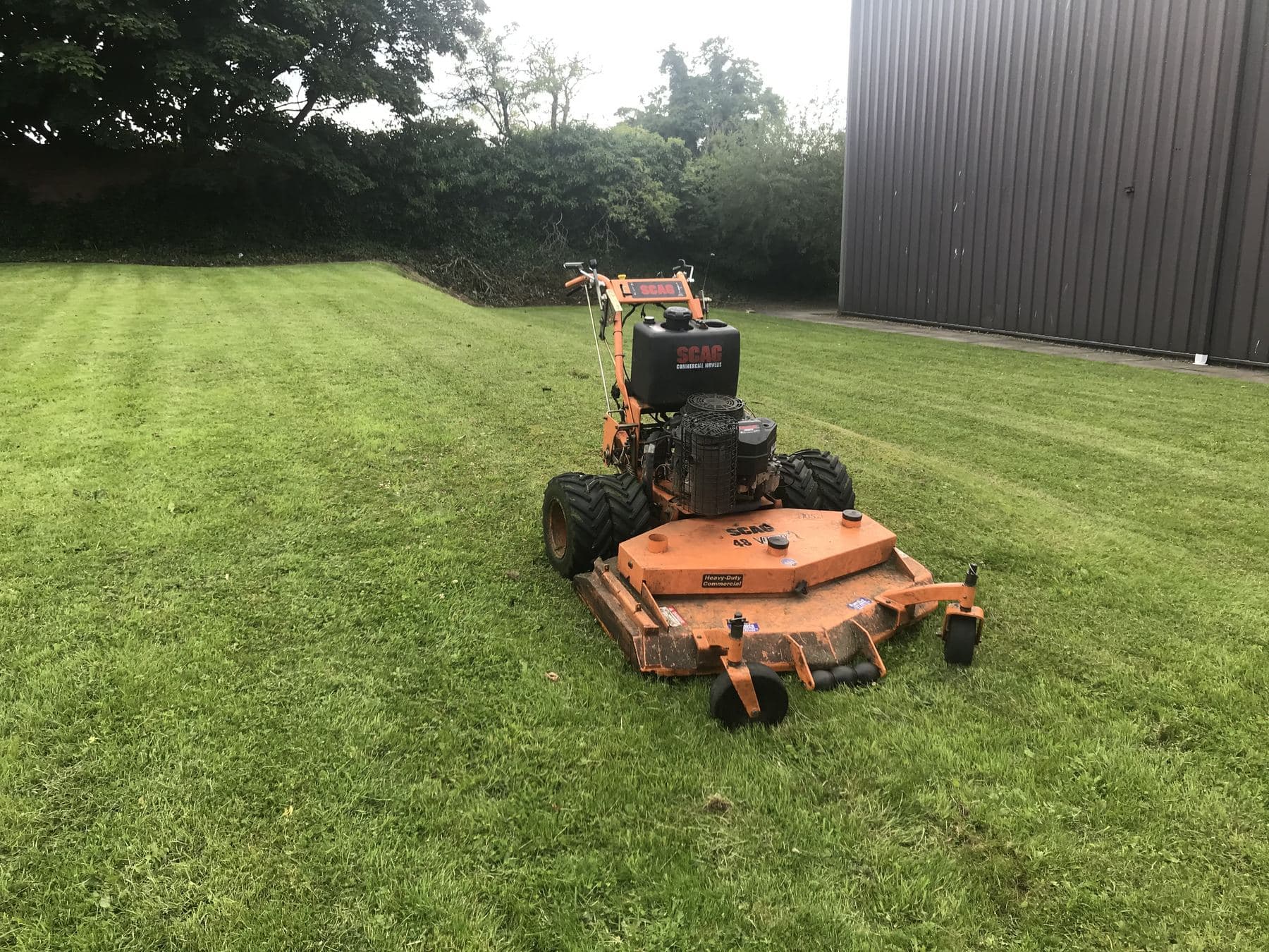 Ride-on mower leaving a striped finish on a large lawn maintained by McKay Landscapes Scotland
